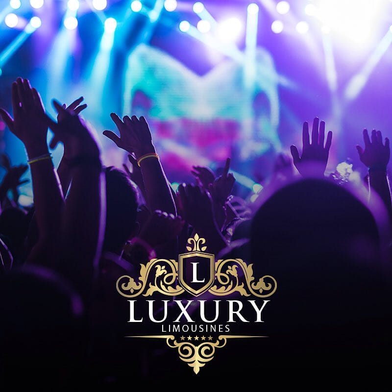 Concert crowd with raised hands under purple and blue stage lights Las Vegas nightlife limo service